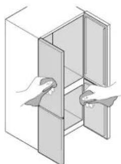 Illustration of two hands inserting a component into a cabinet (no text or symbols).