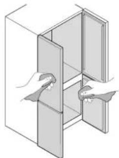 Illustration of two hands inserting a component into a cabinet (no text or symbols)