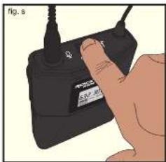 Hand holding a black electronic device with a label, no visible text or symbols on the device itself