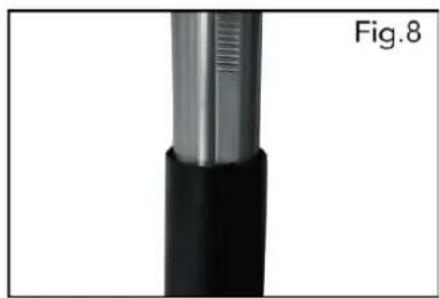 Close-up of a metallic cylindrical object with a black base and textured top, labeled Fig.8 (no text or symbols on the object itself)