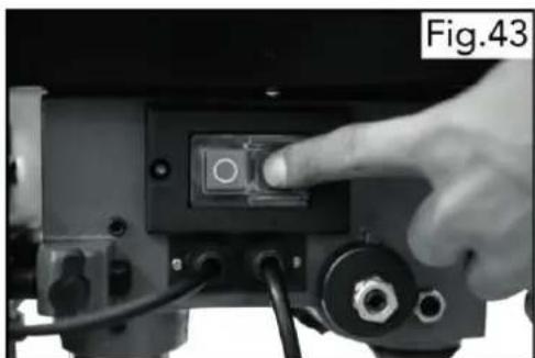 Close-up of a hand pressing a button on a device component (no visible text or symbols)