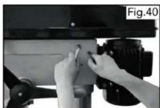 Close-up of hands adjusting a mechanical component with a tool (no visible text or symbols)