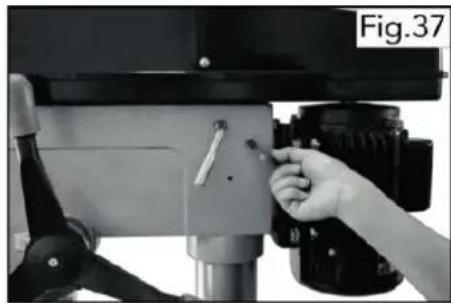 Close-up of a hand adjusting a camera lens on a tripod stand (no visible text or symbols)