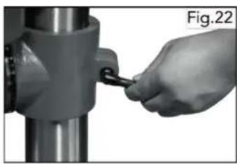 Hand holding a tool interacting with a mechanical component (no visible text or symbols)