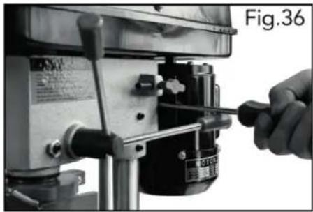 Close-up of a hand using a screwdriver to adjust or install a mechanical component (no visible text or symbols)