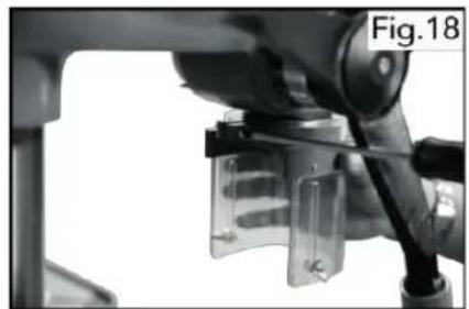 Close-up of a robotic arm holding a transparent cylindrical device, with no visible text or symbols on the device itself.