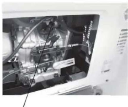 Close-up of a mechanical engine bay with visible hoses and components (no text or symbols)
