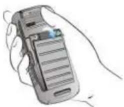 Hand holding a mobile phone with visible keypad and screen (no text or symbols)