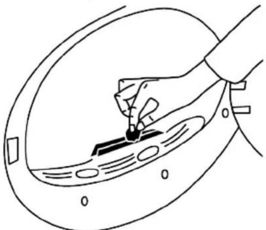Line drawing of a hand holding a small object through a curved surface, with no visible text or symbols