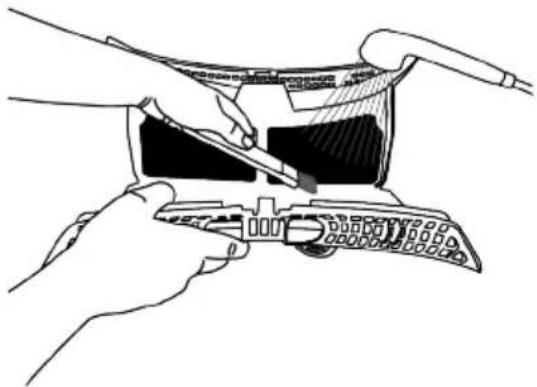 Illustration of hands using a tool to adjust or install a device (no text or symbols visible)