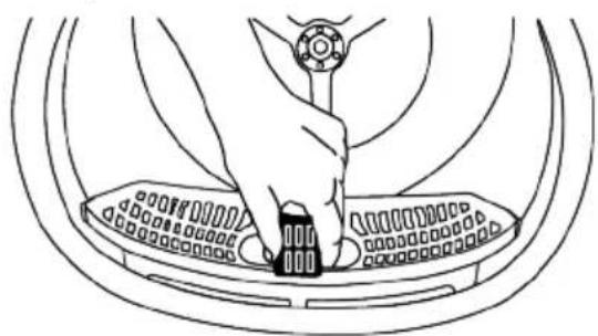 Line drawing of a hand pressing down on a mechanical component (no text or symbols)