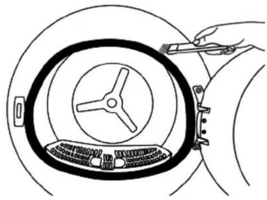 Line drawing of a hand holding a tool interacting with a circular mechanical component (no text or symbols)