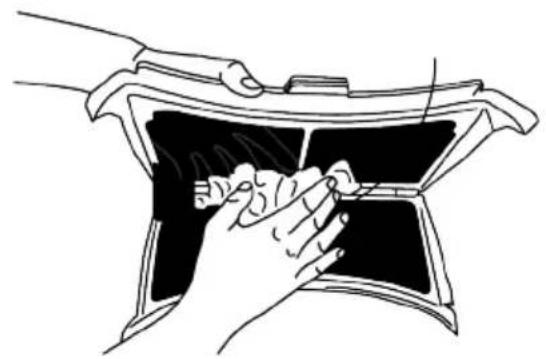 Line drawing of a hand holding a small object inside a mechanical component (no text or symbols)