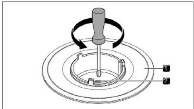 Diagram showing a mechanical device with labeled parts, including a screwdriver and circular components.