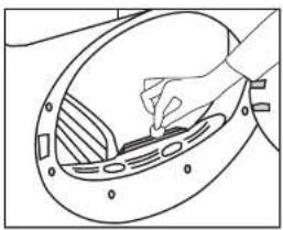 Line drawing of a hand placing a small object into a circular component (no text or symbols)