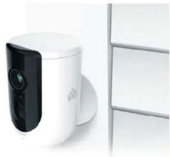 White and black digital camera module next to a white shelf (no visible text or symbols)