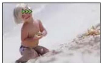 Baby sitting on sandy beach with scattered stones (no text or symbols visible)