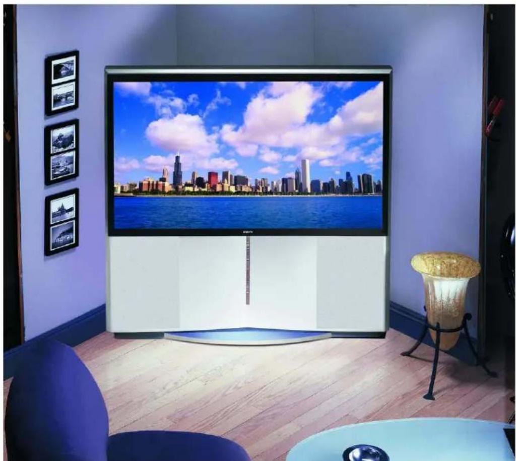 Modern interior scene with a large TV displaying a city skyline over water, surrounded by framed photos and a decorative table (no visible text or symbols)