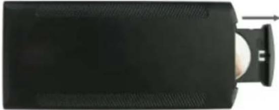 Top-down view of a black rectangular device with a white circular component and a curved handle, showing no visible text or symbols.