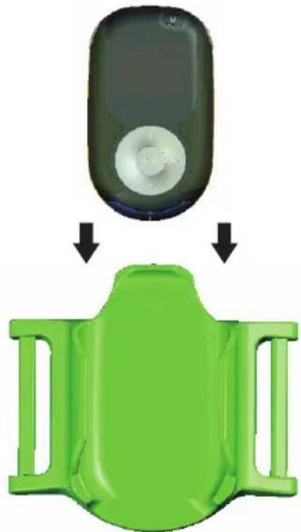 Green plastic device with a circular button and two black arrows pointing to its side panel (no text or symbols)