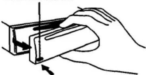 Hand holding a rectangular object with a vertical line and arrow indicating direction (no text or symbols)