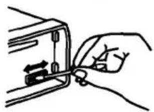 Hand holding a tool interacting with a mechanical component (no text or symbols visible)