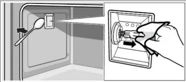 Illustration showing a hand inserting a screw into a door panel, with a spoon inserted (no text or symbols)