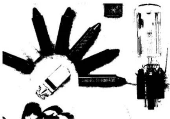 Abstract black-and-white illustration of a mechanical component with multiple blades and a cylindrical housing (no text or symbols)