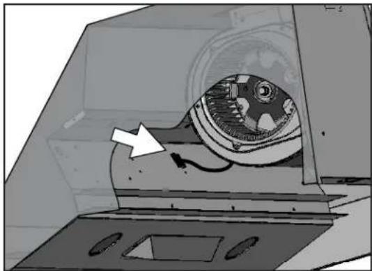 Mechanical device interior view showing internal components and a white arrow pointing to a component (no text or symbols visible)