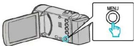 Diagram showing a digital camera with an 'MENU' button and a hand cursor icon, likely illustrating a menu or navigation interface.