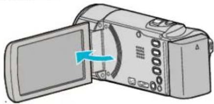 Illustration of a digital camera with an open screen and a blue arrow indicating the direction (no text or symbols present)