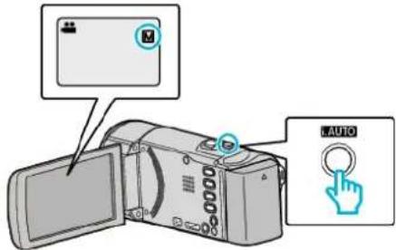 Diagram showing a digital camera with an attached device labeled 'AUTO' and a hand icon pointing to it.