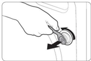 Hand holding a circular mechanical component with a curved arrow indicating rotation (no text or symbols)