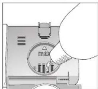 Hand inserting a device into a circular control panel (no text or symbols visible)