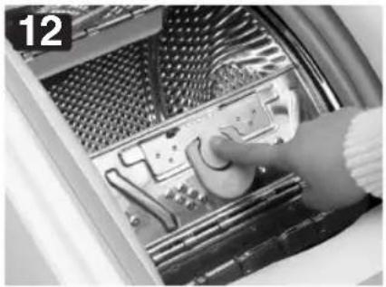Close-up of a hand operating a control panel inside an electronic device (no visible text or symbols)
