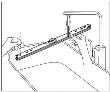 Line drawing of a hand holding a metal bracket with a pipe, no text or symbols present