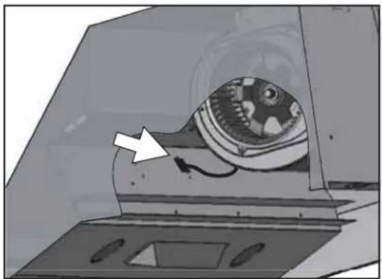 Illustration of a mechanical device inside a chamber with an arrow pointing to a component (no text or symbols visible)