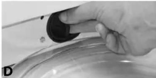 Close-up of a hand holding a black knob on a metallic surface, no visible text or symbols