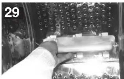 Close-up of a person using a tool on a mechanical component, no visible text or symbols