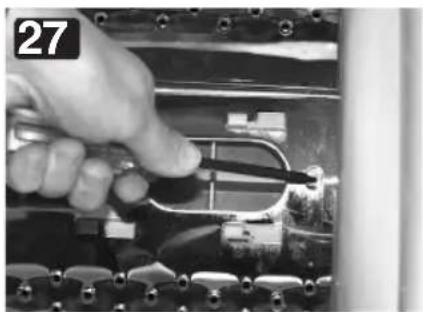 Close-up of a hand using a tool to adjust or install electronic components (no visible text or symbols)
