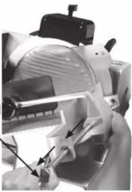 Close-up of a hand using a tool to adjust or install a mechanical component (no visible text or symbols)