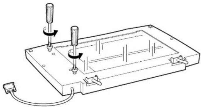 Technical line drawing of a mechanical assembly with two screwdrivers and a base plate (no text or symbols)
