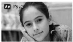 Black-and-white photo of a young woman with hand on cheek, no visible text or symbols