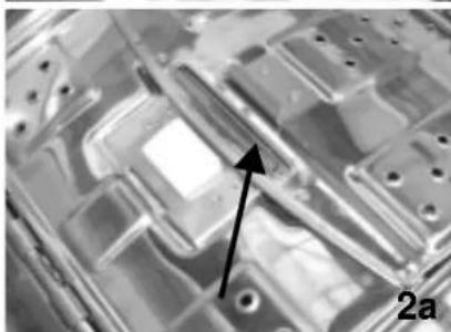 Microscopic view of a semiconductor or electronic component with an arrow pointing to a specific feature, labeled '2a' (no readable text or symbols beyond label)