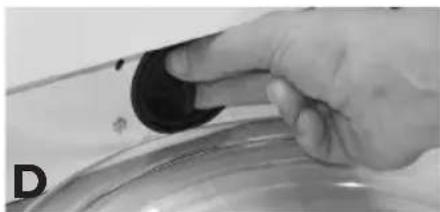 Close-up of a hand holding a black knob over a metallic bowl (no visible text or symbols)