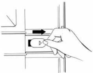 Hand holding a button on a mechanical component (no text or symbols visible)