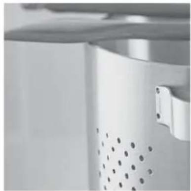 Close-up of a white industrial machine with perforated door and mounting bracket (no visible text or symbols)