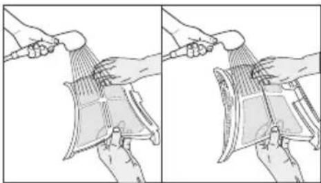 Illustration of two hands using a tool to lift a device into a tray (no text or symbols visible)