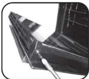 Close-up of a metallic mechanical component with a tool inserted, showing internal structure and grid lines (no text or symbols visible)