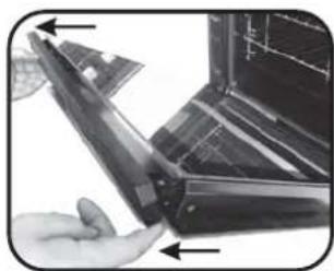 Close-up of a hand holding a rectangular electronic device with a screen, showing internal components (no visible text or symbols)